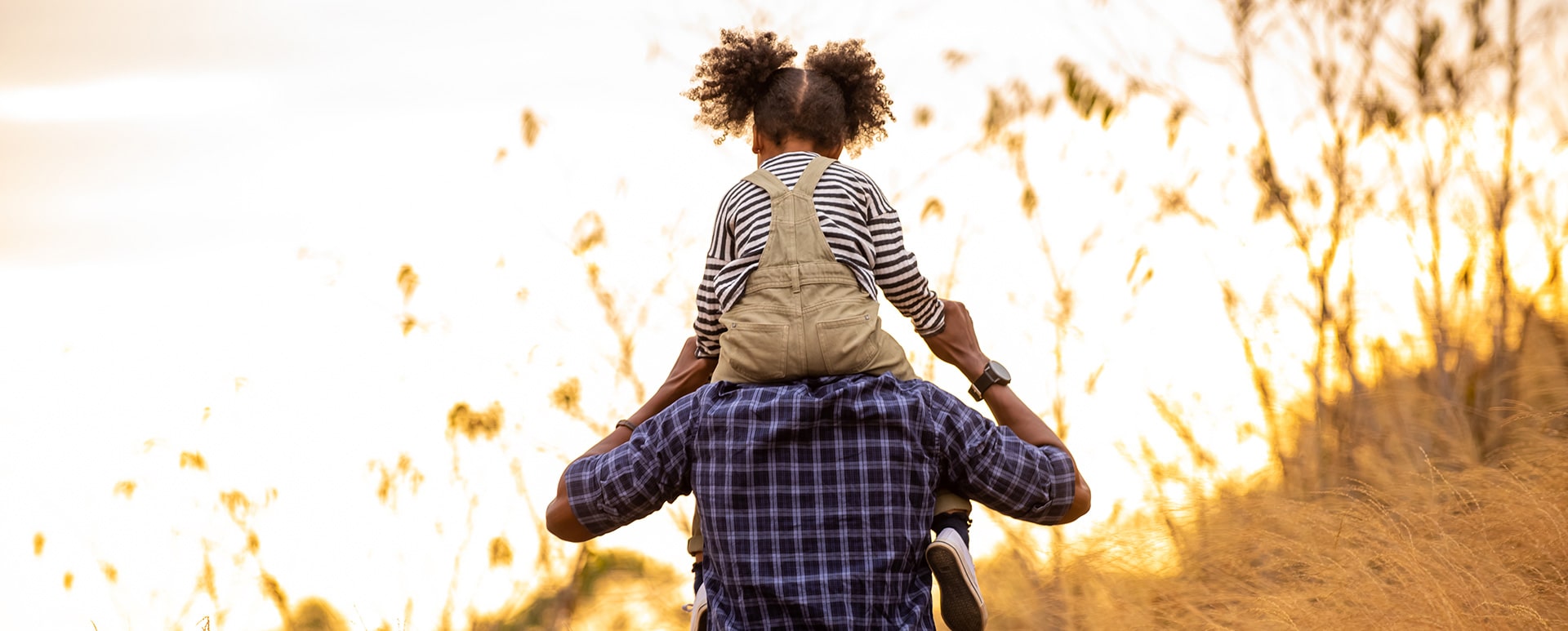 kid on fathers shoulders