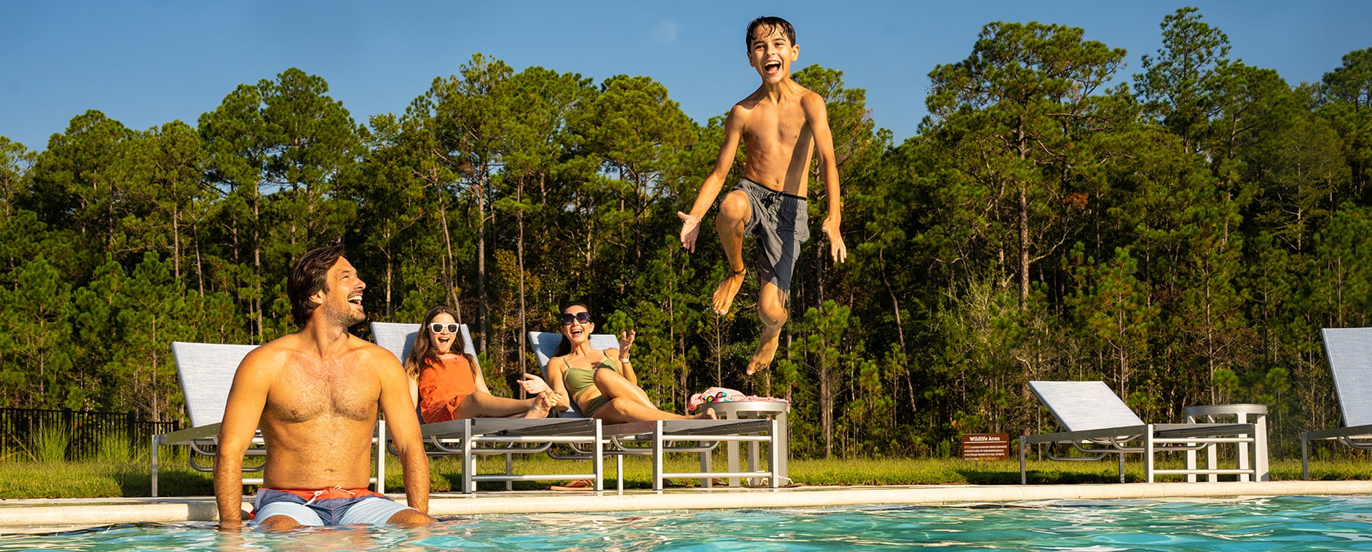 Kid jumping into a pool