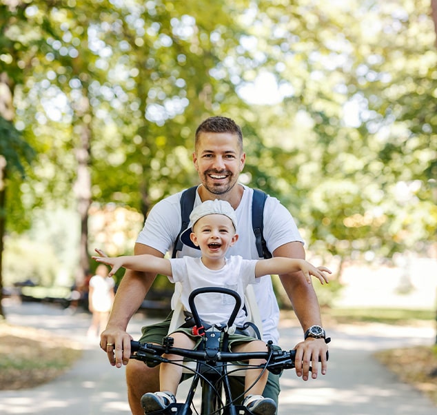 father and daughter riding a bike