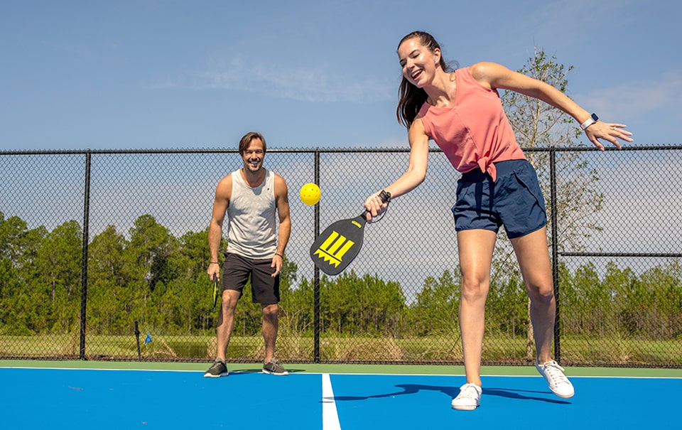 couple playing on pickleball court - future wylder