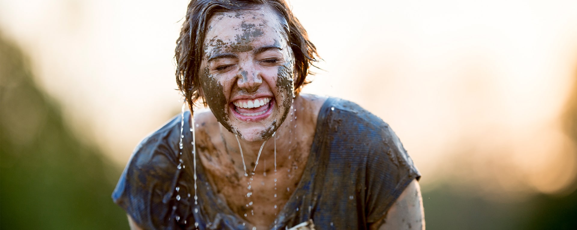 woman smiling after muddy run