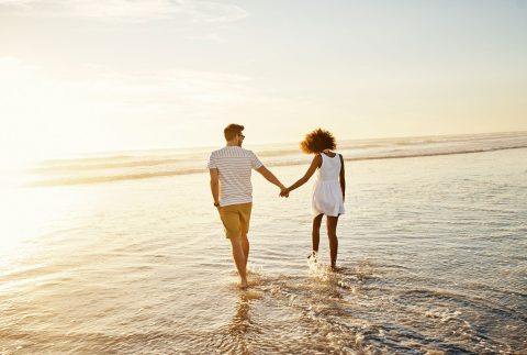 couple walking on the beach in st lucie county