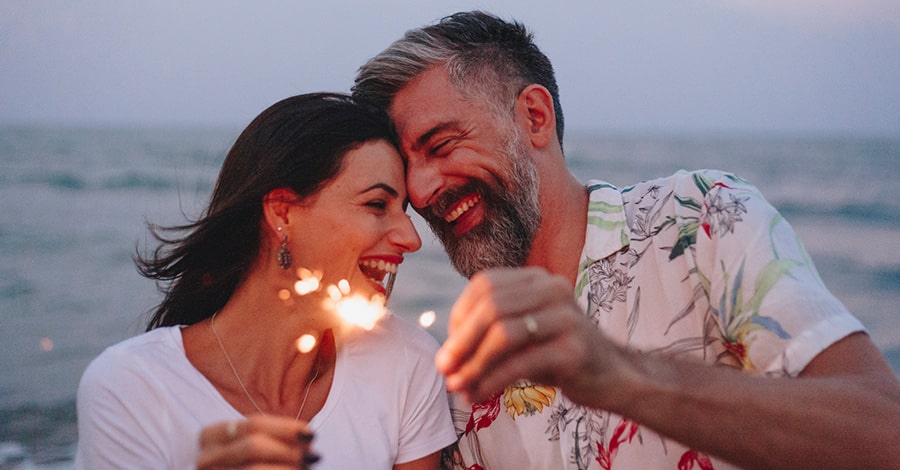 Couple on the beach with sparklers