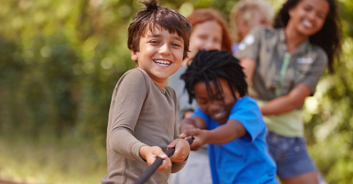 kids playing tug-a-war in home community