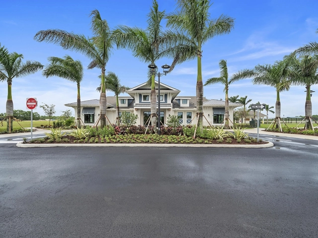 Entrance to the Wylder Port St. Lucie clubhouse lined with palm trees