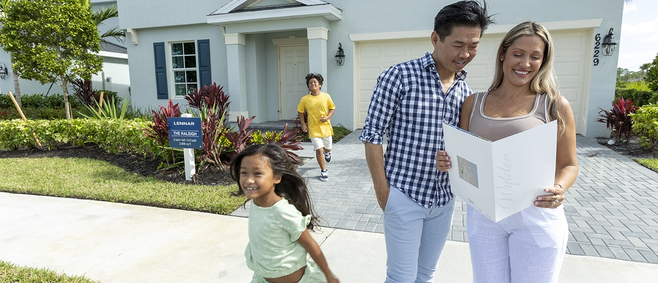 Family walking outside a model home at Brystol at Wylder