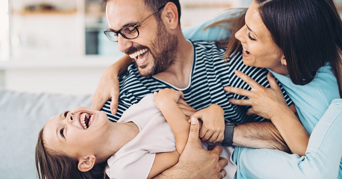 Family laughing together inside a modern new construction home