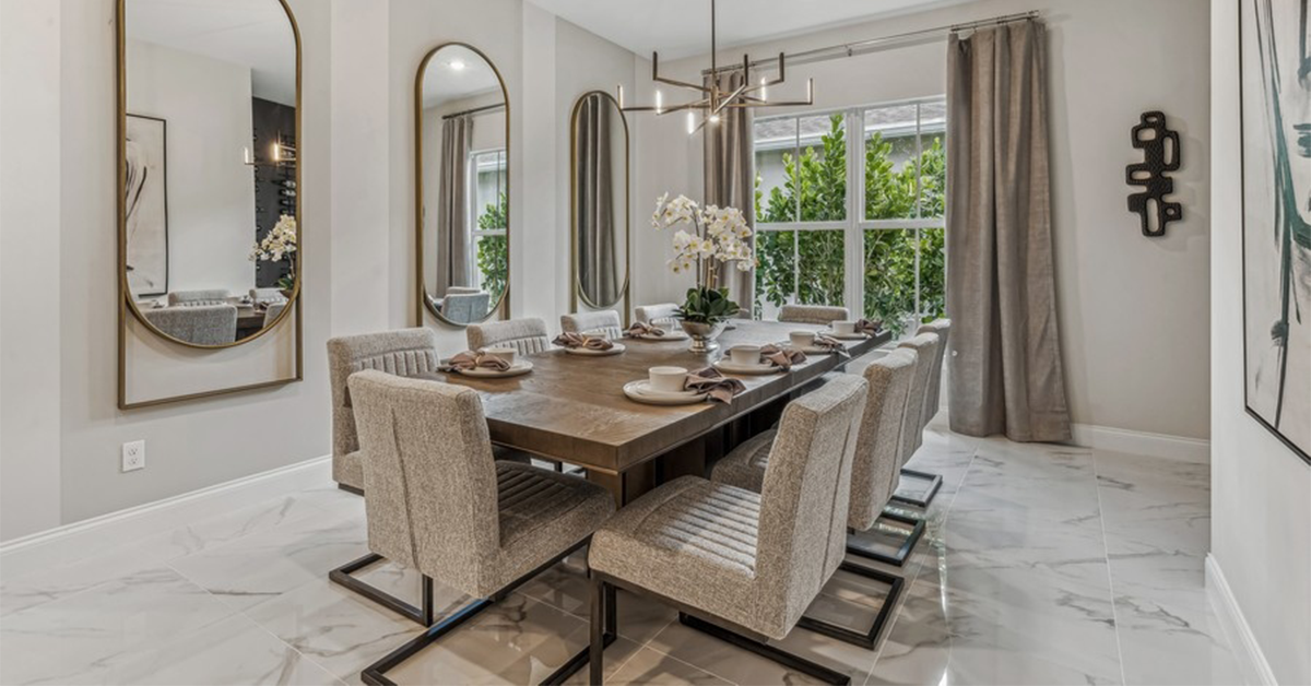 Covered lanai with dining table overlooks pool and water view.