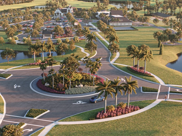 Aerial rendering of a landscaped roundabout with palm trees, leading to a clubhouse complex, parking lot, and golf driving range.