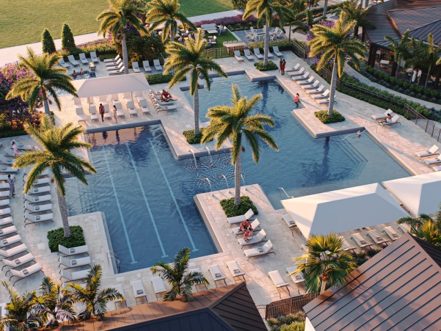 Aerial rendering at golden hour of a resort pool complex with a spa, lap pool, lounge chairs, and a clubhouse building in the background.