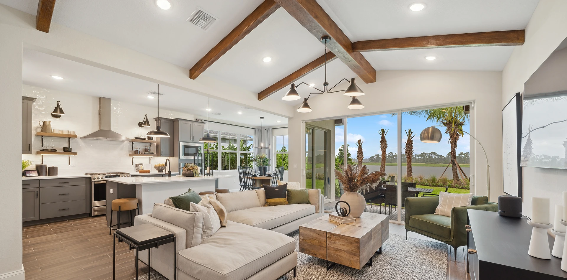 Modern open-concept living room and kitchen with exposed wood beams